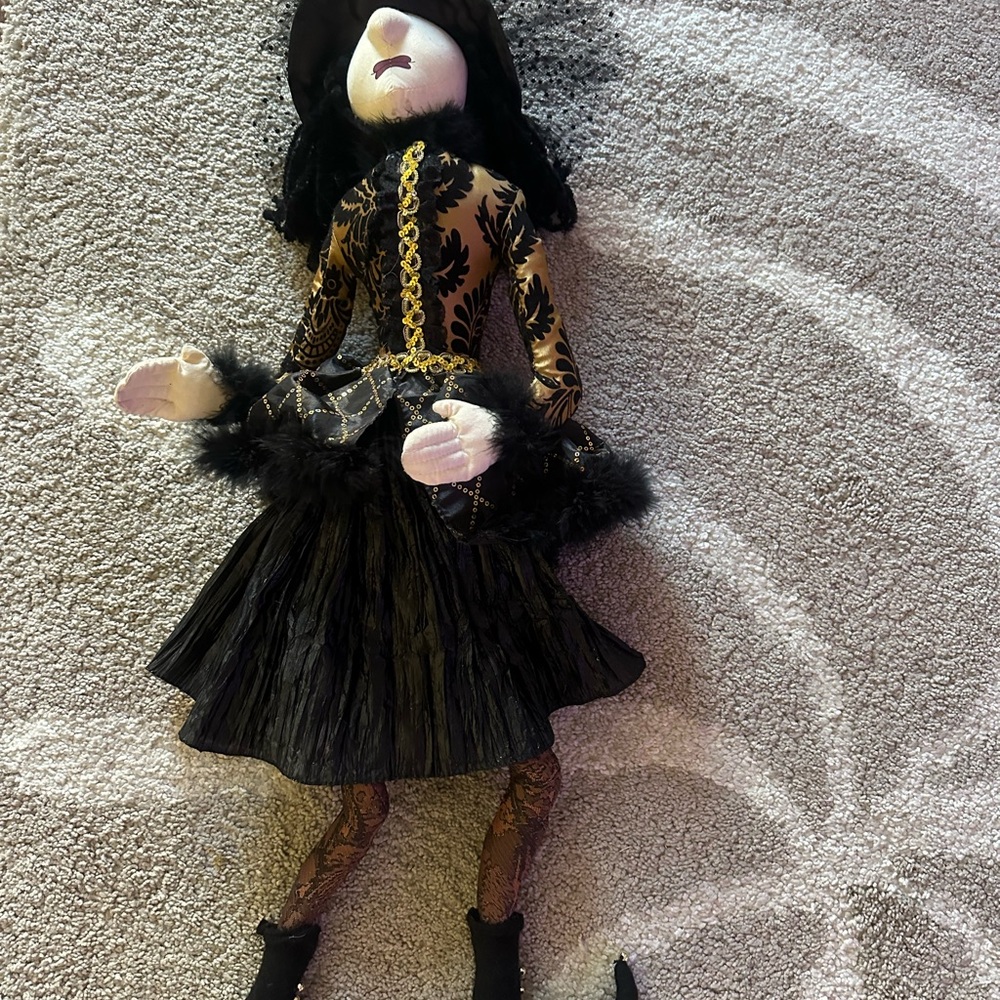 Elegant Black and Gold Doll with Feather Details